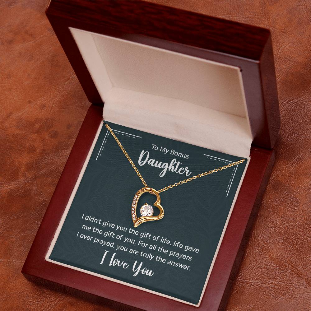 Gift box with a heart pendant necklace on It. 14k white gold finish or 18k yellow gold finish 6.5mm round cut cubic zirconia stone Pendant dimensions: 0.8" (2.2cm) height / 0.7" (1.8cm) width Adjustable chain length: 18" - 22" (45.72cm - 55.88cm) Lobster clasp attachment