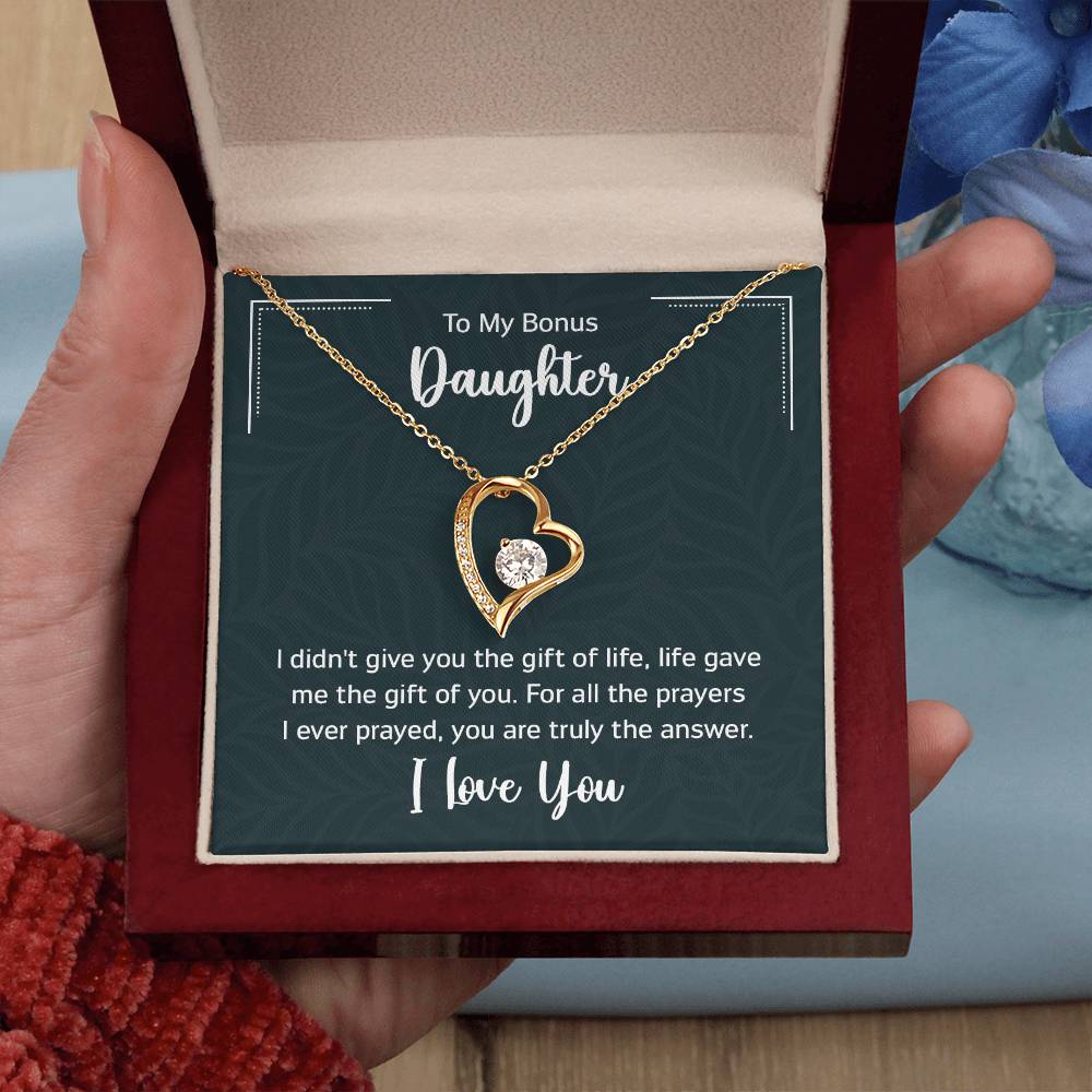 Gift box with a heart pendant necklace on It. 14k white gold finish or 18k yellow gold finish 6.5mm round cut cubic zirconia stone Pendant dimensions: 0.8" (2.2cm) height / 0.7" (1.8cm) width Adjustable chain length: 18" - 22" (45.72cm - 55.88cm) Lobster clasp attachment