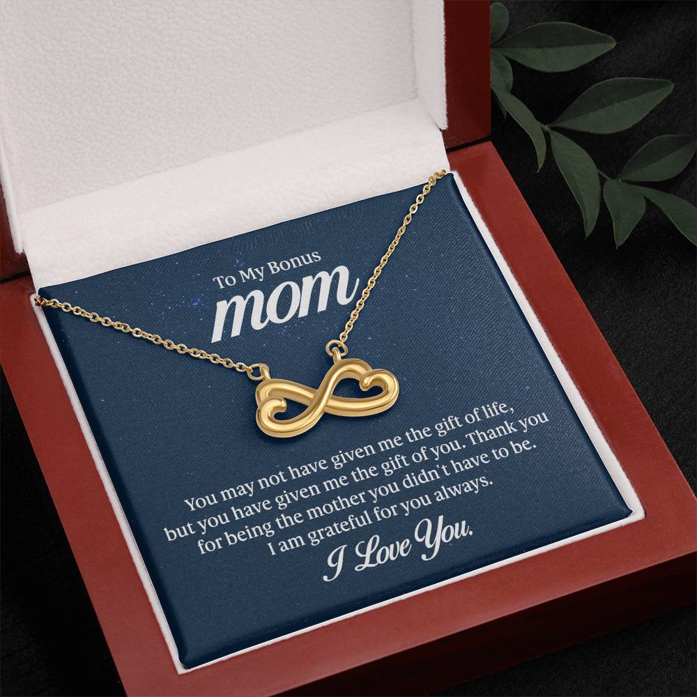Endless Love Necklace on a gift card, showcasing a heart-shaped infinity symbol in 18k yellow gold finish, artisan-crafted and hand-polished.