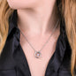 Woman wearing a necklace with a Horseshoe pendant necklace with a cubit zirconia crystal Product Details: White Gold Over Stainless Steel Cubic Zirconia Crystal Pendant size approximately 0.77” x 0.62” inches (19.5mm x 16mm) Adjustable box chain measures 16" - 18" Lobster clasp attachment