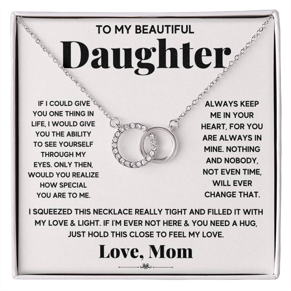 picture if of a card with a necklace on it with two interlocking circles on it