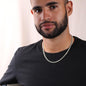 man wearing a Men's necklace on a gift card, crafted from polished stainless steel, featuring a chain width of 5 mm, adjustable length of 18 to 22 inches, weighing 28.5 grams, with a parrot clasp.