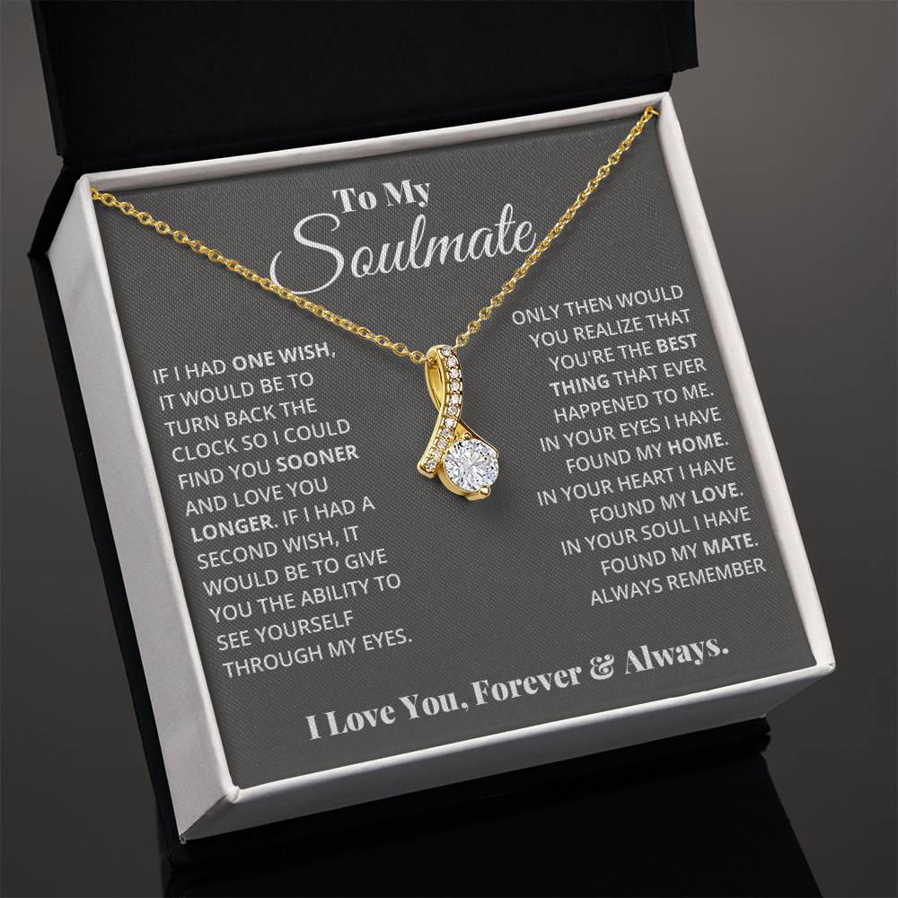 Jewelry card gift with a necklace on it, the necklace is a single pendant with a large cubit zirconia suspended by a curved bar with smaller cubit zirconia