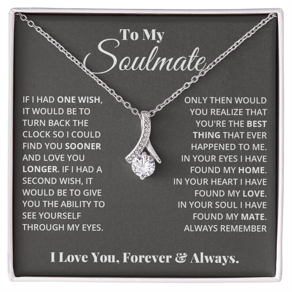 Jewelry card gift with a necklace on it, the necklace is a single pendant with a large cubit zirconia suspended by a curved bar with smaller cubit zirconia