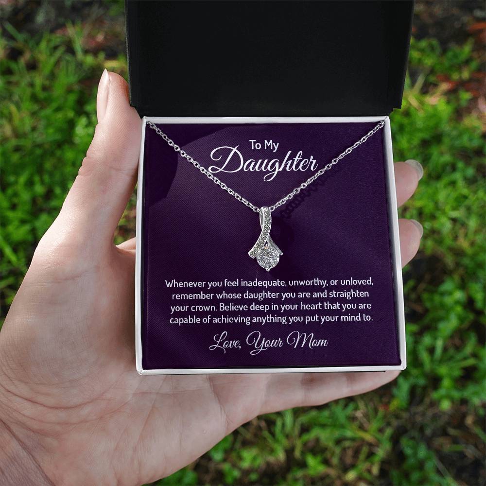 Alluring Beauty necklace features a petite ribbon shaped pendant that is sure to dazzle your special someone. Whether it's a birthday or anniversary, make sure to get her a gift she will love for years to come.