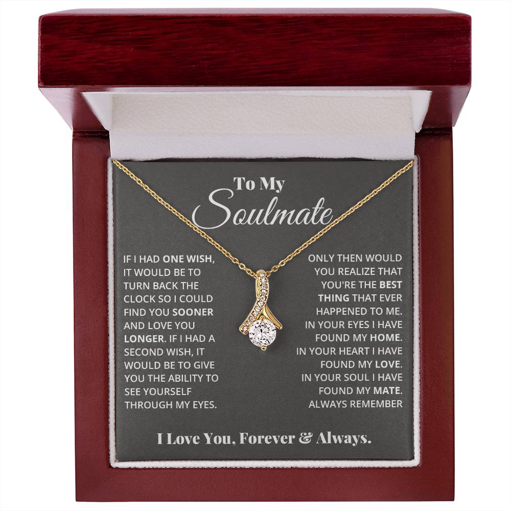 Jewelry card gift with a necklace on it, the necklace is a single pendant with a large cubit zirconia suspended by a curved bar with smaller cubit zirconia