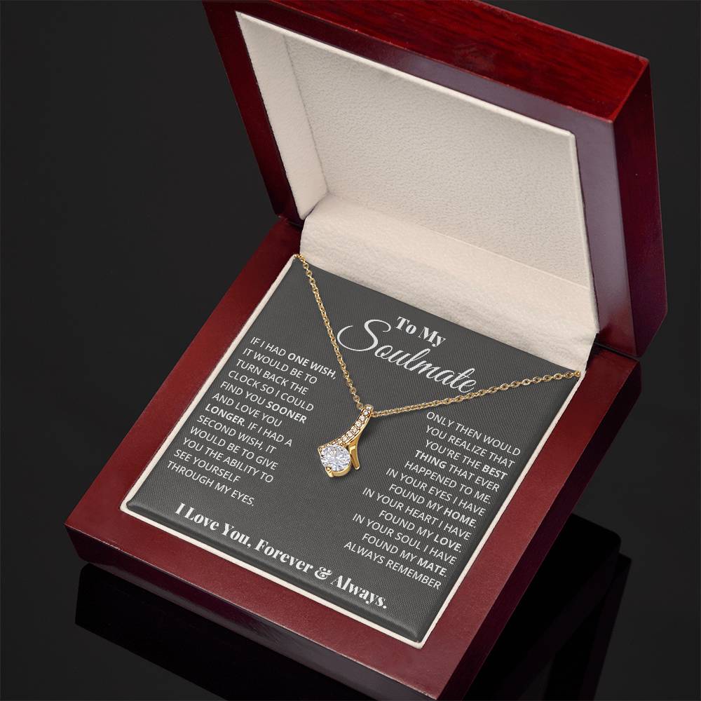 Jewelry card gift with a necklace on it, the necklace is a single pendant with a large cubit zirconia suspended by a curved bar with smaller cubit zirconia
