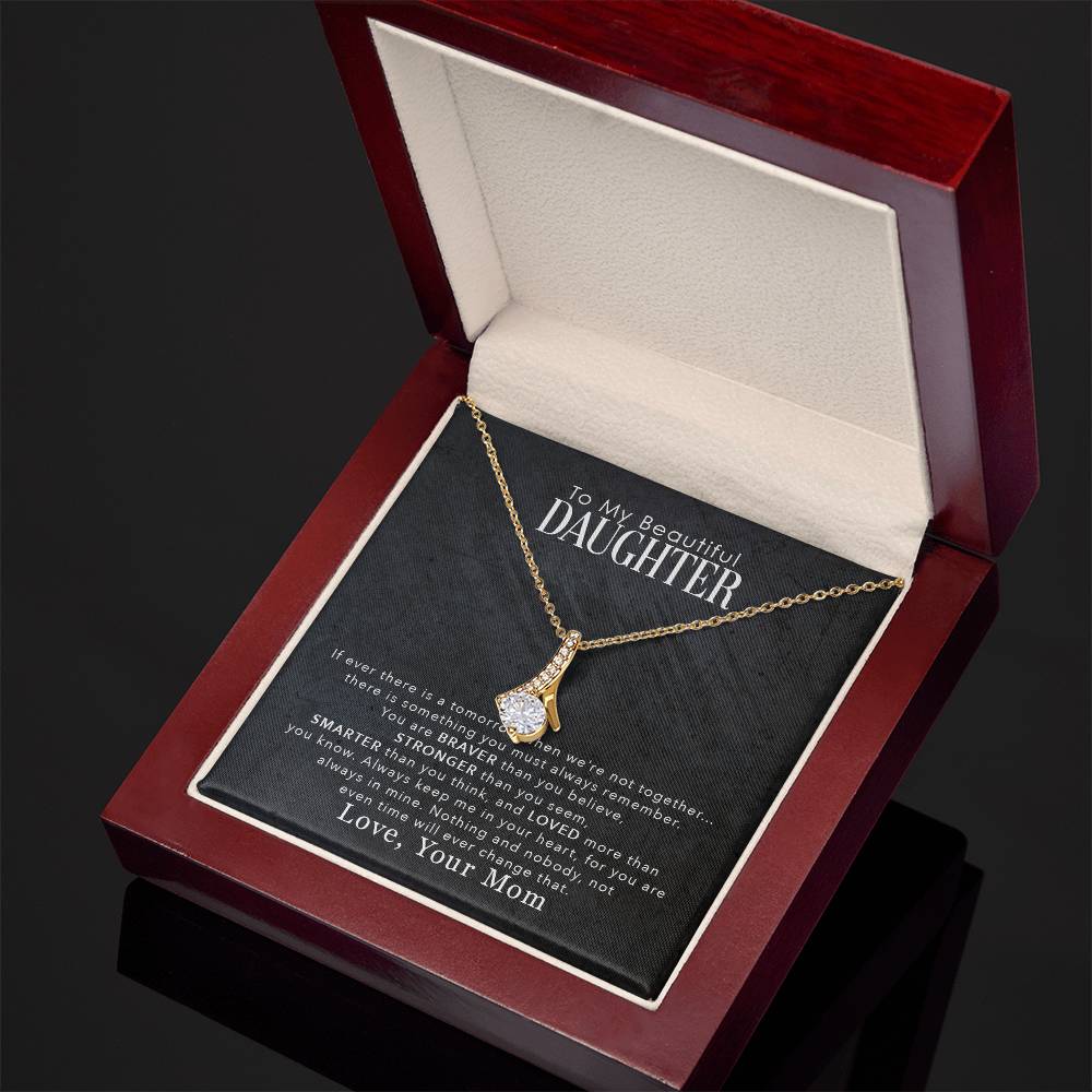 jewelry card with a necklace on it the necklace has a large cubit zirconia in the middle and is suspended on a lpiece of metal with numerous small cubity zirocnia on it