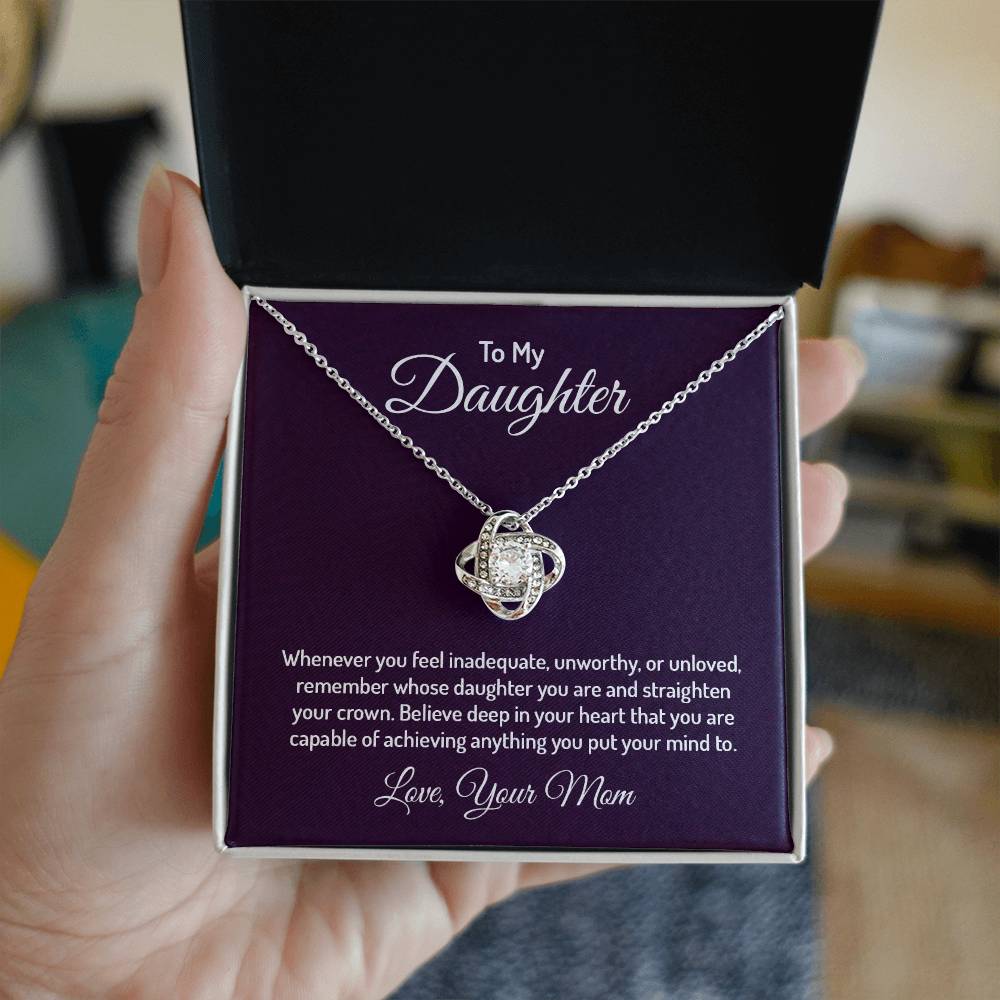 Gorgeous Love Knot Necklace with a pendant adorned with cubic zirconia crystals, available in 14k white gold or 18k yellow gold over stainless steel, adjustable from 18 to 22 inches.