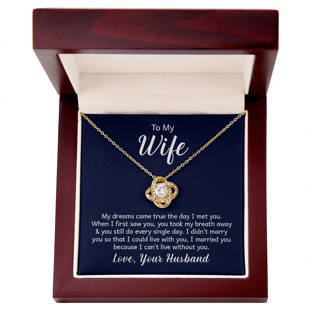 "18k yellow gold over stainless steel love knot necklace on a gift card, showcasing a 6mm round cut cubic zirconia stone and adjustable chain length from 18 to 22 inches."