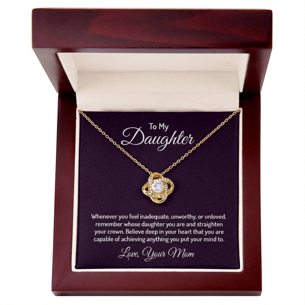 Gorgeous Love Knot Necklace with a pendant adorned with cubic zirconia crystals, available in 14k white gold or 18k yellow gold over stainless steel, adjustable from 18 to 22 inches.