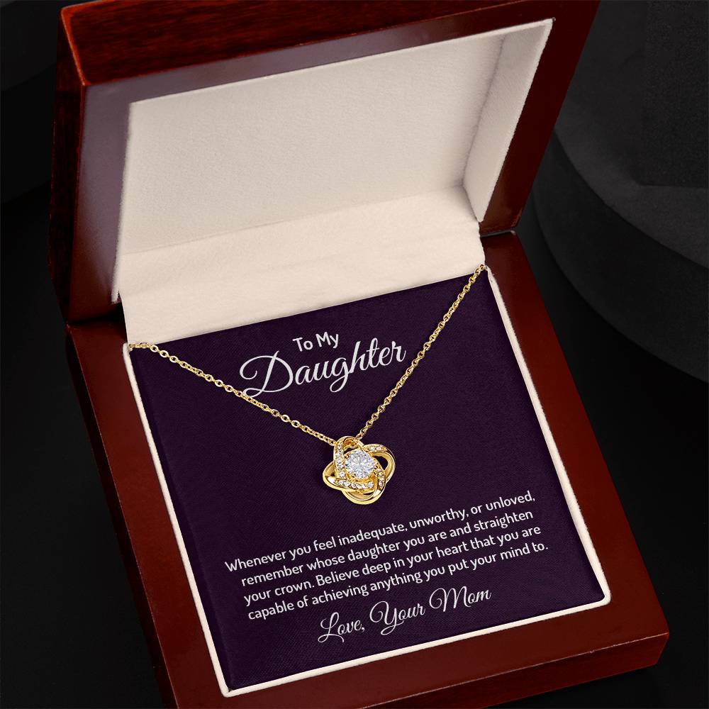 Gorgeous Love Knot Necklace with a pendant adorned with cubic zirconia crystals, available in 14k white gold or 18k yellow gold over stainless steel, adjustable from 18 to 22 inches.