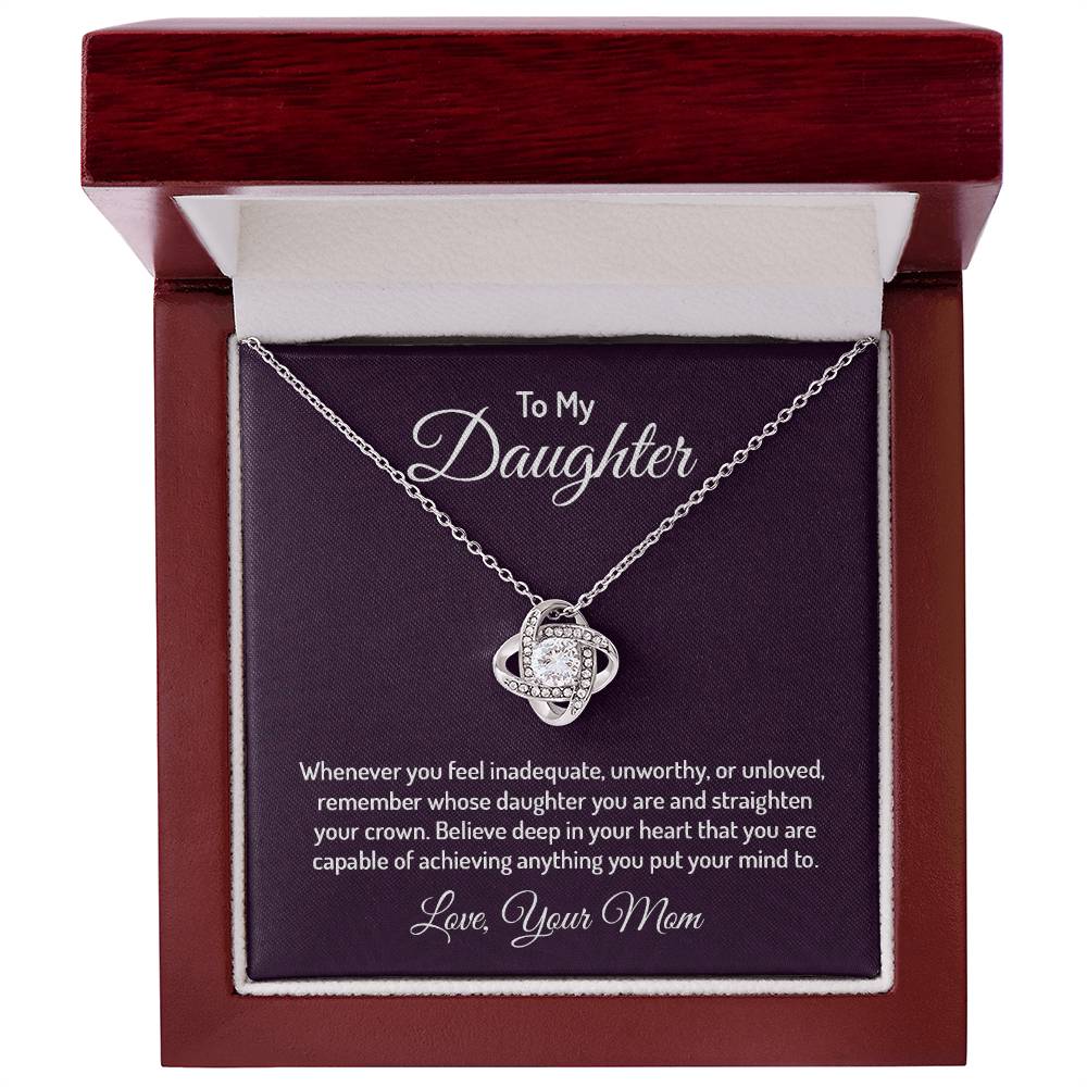 Gorgeous Love Knot Necklace with a pendant adorned with cubic zirconia crystals, available in 14k white gold or 18k yellow gold over stainless steel, adjustable from 18 to 22 inches.