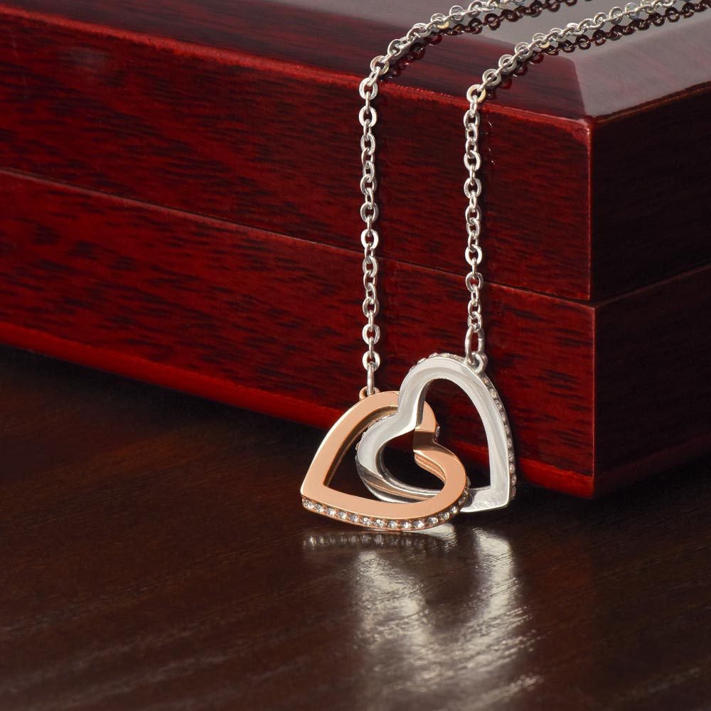 Necklace featuring two heart pendants adorned with CZ crystals, available in polished surgical steel with a rose gold or 18k yellow gold finish, adjustable from 18 to 22 inches.