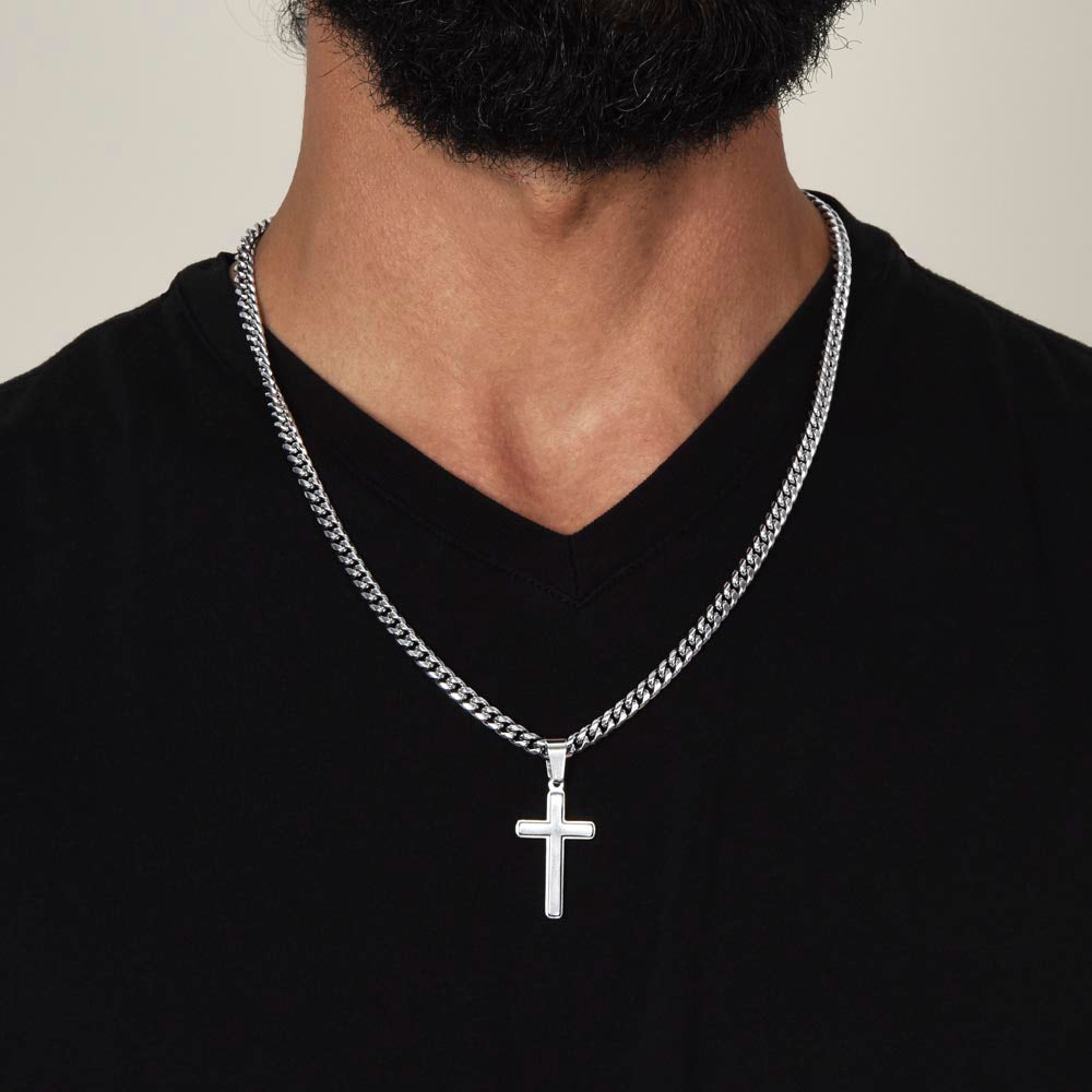 A man wearing a heavy Cuban link chain with a croos necklace