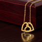Woman wearing a necklace featuring two heart pendants adorned with CZ crystals, available in polished surgical steel with a rose gold or 18k yellow gold finish, adjustable from 18 to 22 inches.
