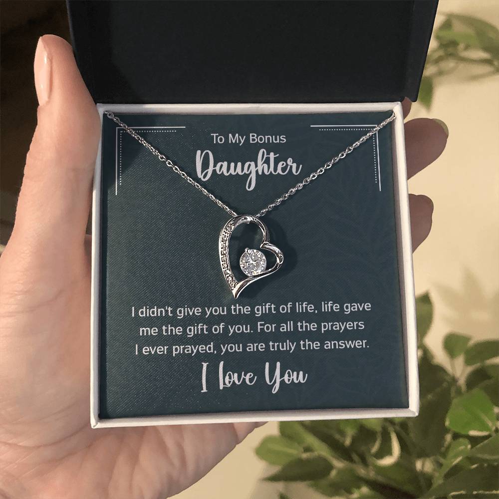 Gift box with a heart pendant necklace on It. 14k white gold finish or 18k yellow gold finish 6.5mm round cut cubic zirconia stone Pendant dimensions: 0.8" (2.2cm) height / 0.7" (1.8cm) width Adjustable chain length: 18" - 22" (45.72cm - 55.88cm) Lobster clasp attachment