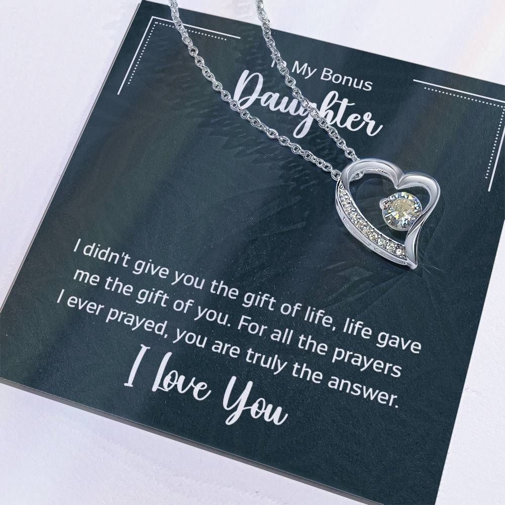 Gift box with a heart pendant necklace on It. 14k white gold finish or 18k yellow gold finish 6.5mm round cut cubic zirconia stone Pendant dimensions: 0.8" (2.2cm) height / 0.7" (1.8cm) width Adjustable chain length: 18" - 22" (45.72cm - 55.88cm) Lobster clasp attachment