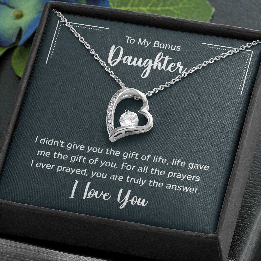 Gift box with a heart pendant necklace on It. 14k white gold finish or 18k yellow gold finish 6.5mm round cut cubic zirconia stone Pendant dimensions: 0.8" (2.2cm) height / 0.7" (1.8cm) width Adjustable chain length: 18" - 22" (45.72cm - 55.88cm) Lobster clasp attachment