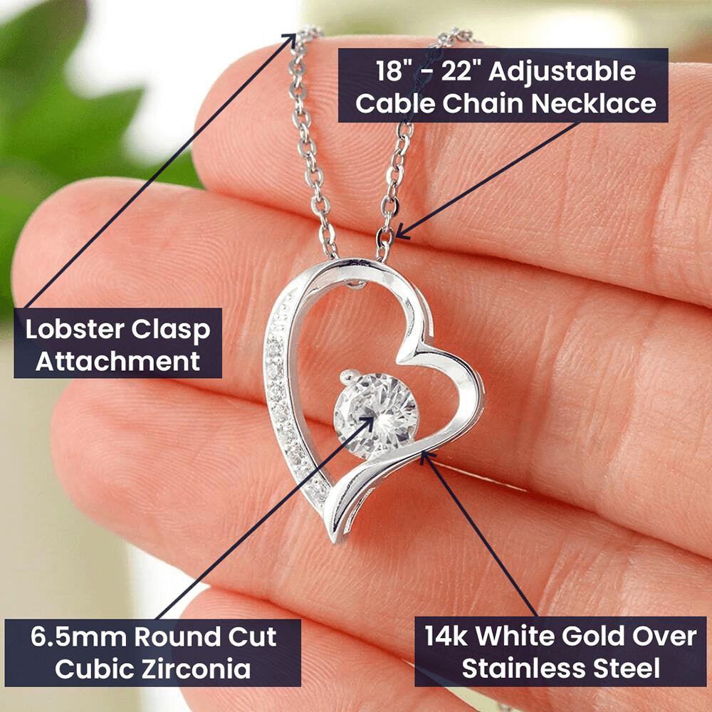 a gift box with a stainless steel heart shapped pedant necklace with a large cz diamond and small ca chip diamonds on the perimeter A