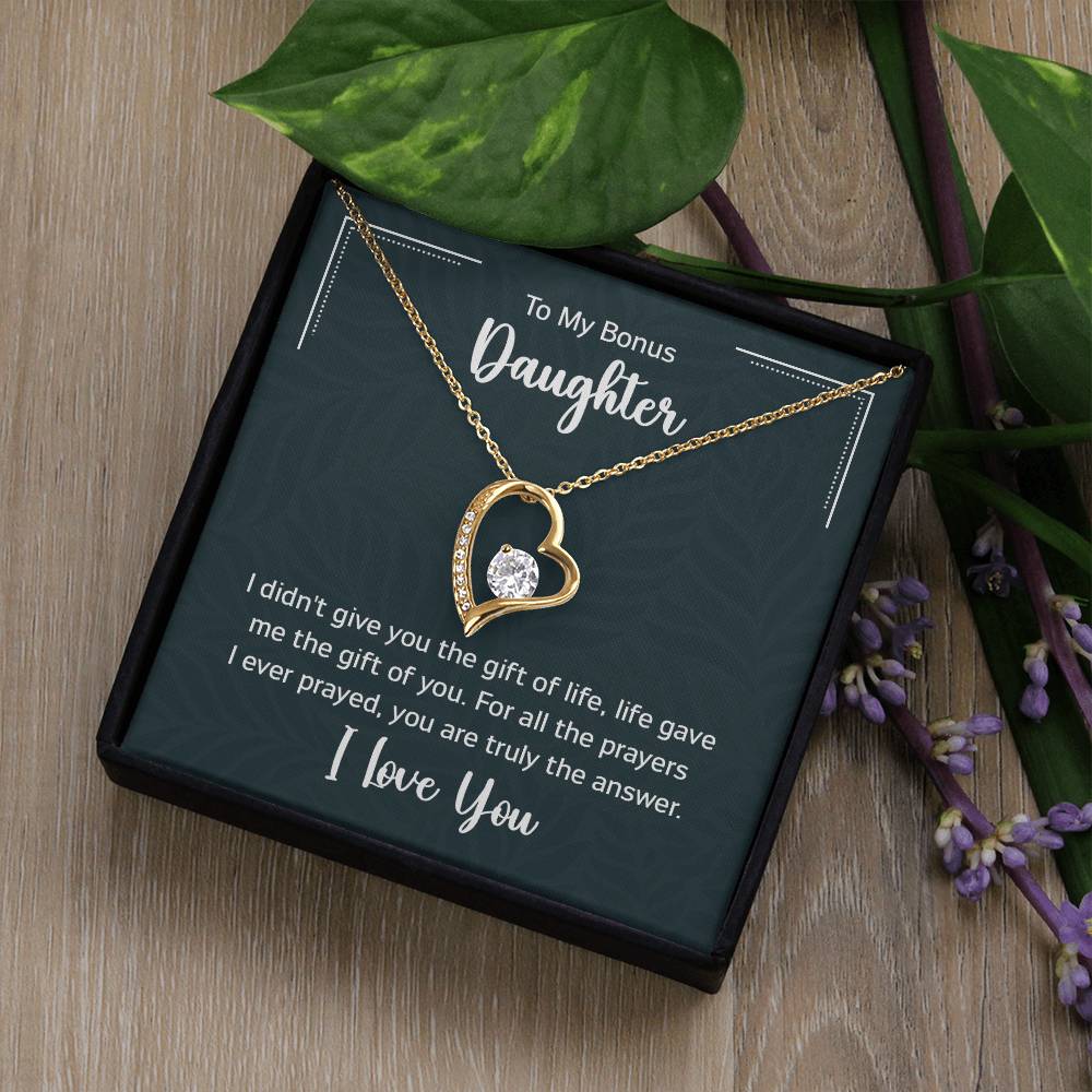 Gift box with a heart pendant necklace on It. 14k white gold finish or 18k yellow gold finish 6.5mm round cut cubic zirconia stone Pendant dimensions: 0.8" (2.2cm) height / 0.7" (1.8cm) width Adjustable chain length: 18" - 22" (45.72cm - 55.88cm) Lobster clasp attachment