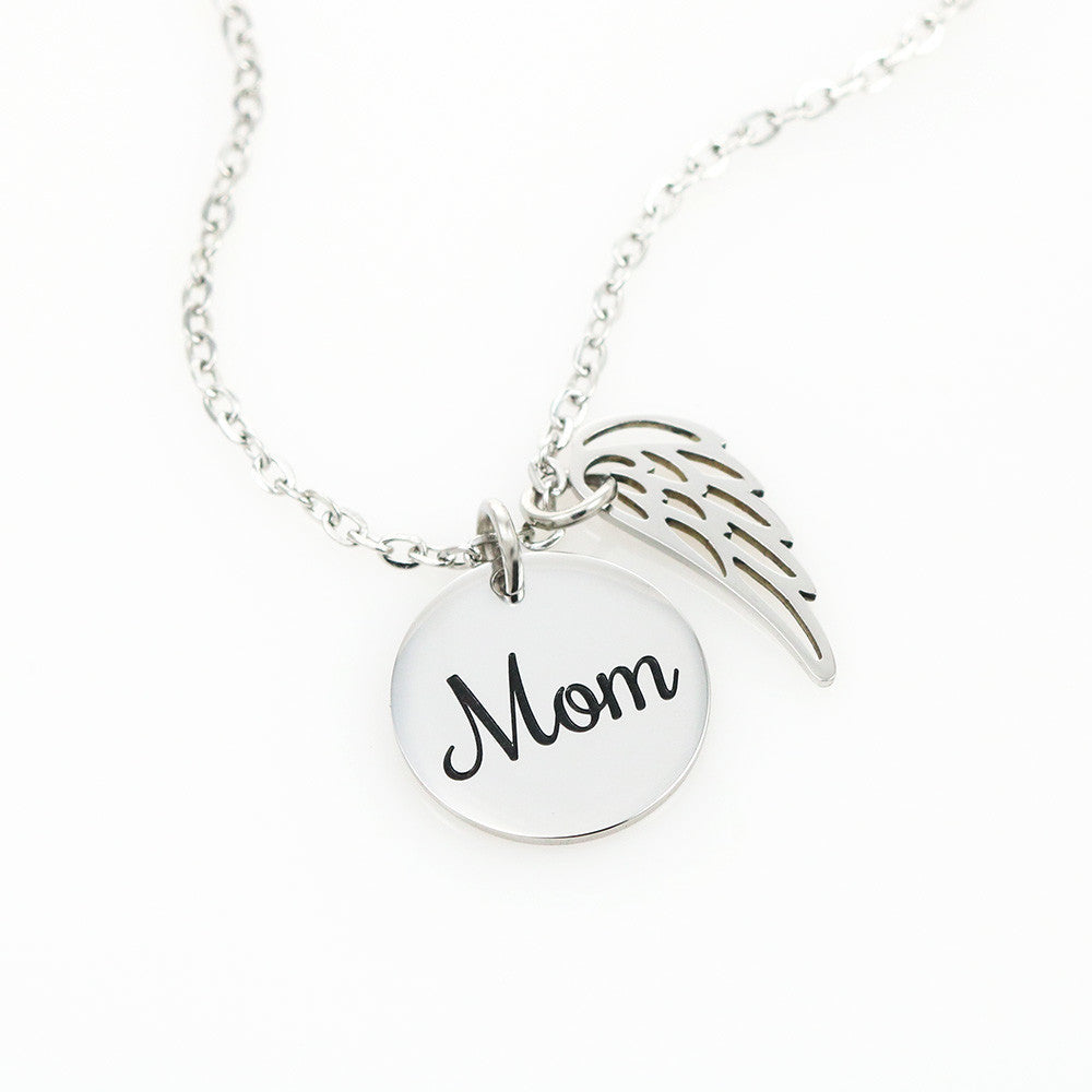 Message card with a memorial necklace Dad Product specifications: Polished Stainless Steel and 18k Yellow Gold over Stainless Steel. Pendant Dimensions, Circle 0.5" (13mm), Wing 0.625" (10mm) Adjustable 18"-22" cable chain Lobster clasp closure.