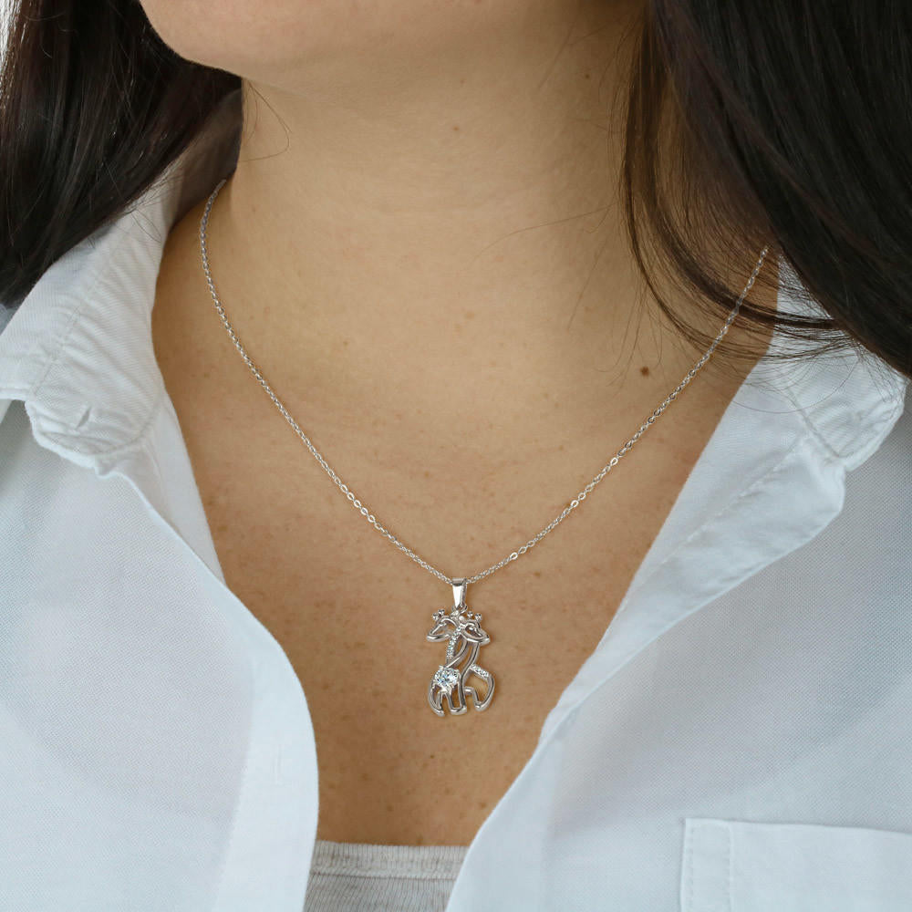 womans chest with 2 giraffes intertwined necklace pendant necklace on it and